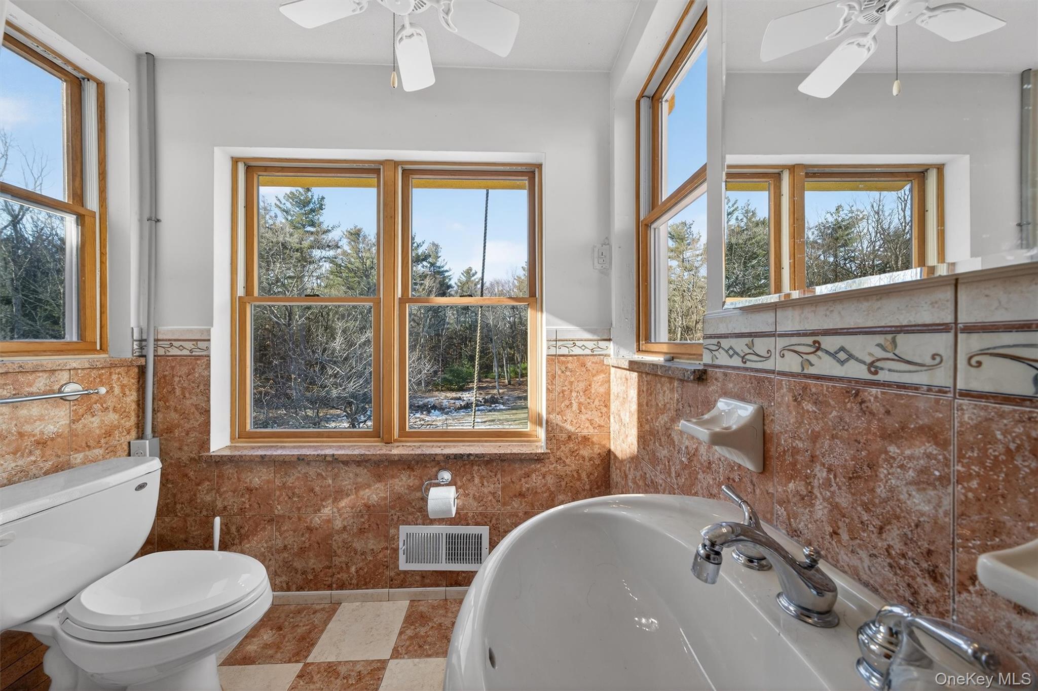 125 Dexheimer Road Narrowsburg, NY 12764 - Photo 24 of 50 Bathroom featuring ceiling fan, wainscoting, and tile walls