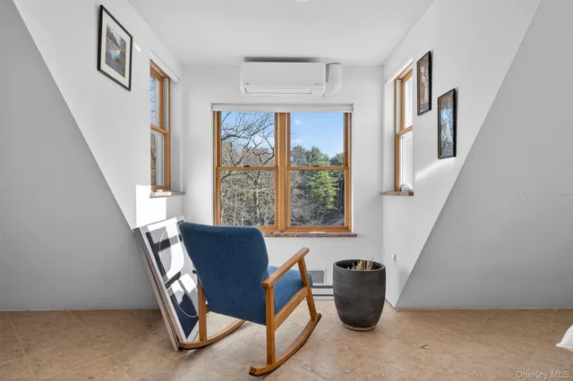 a view of staircase with furniture and a window