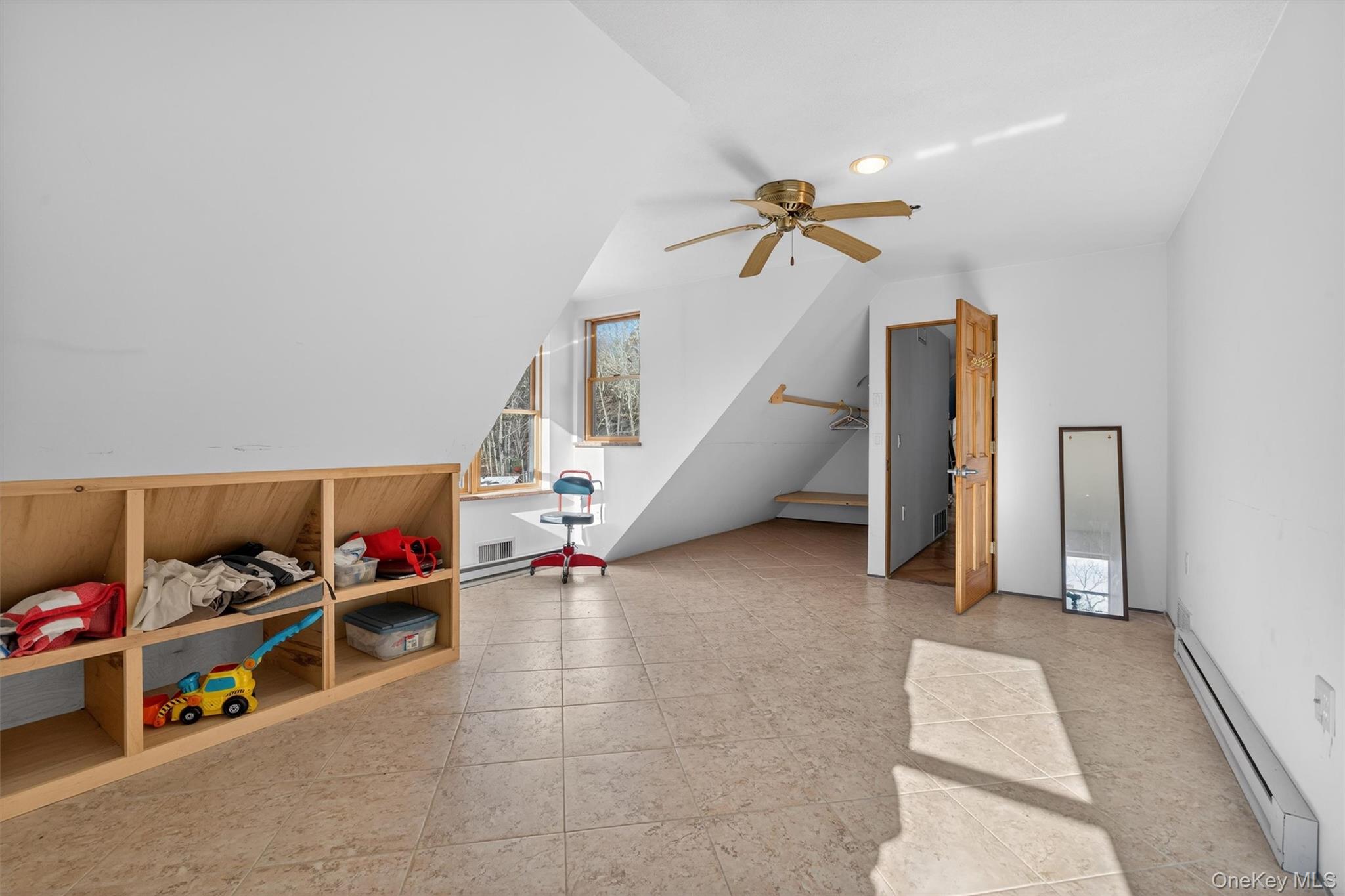 125 Dexheimer Road Narrowsburg, NY 12764 - Photo 28 of 50 Playroom with baseboard heating, a ceiling fan, and lofted ceiling