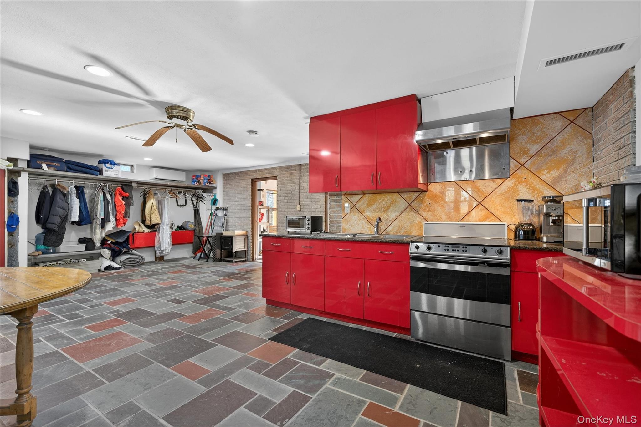 125 Dexheimer Road Narrowsburg, NY 12764 - Photo 29 of 50 Kitchen with red cabinetry, stainless steel range with electric stovetop, a ceiling fan, and stone tile flooring