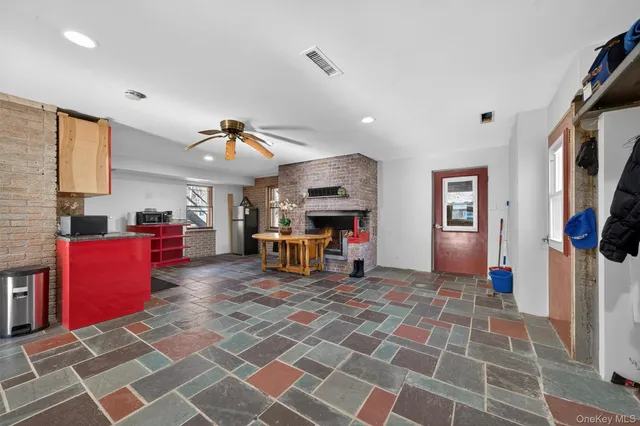 a living room with furniture a flat screen tv and kitchen view