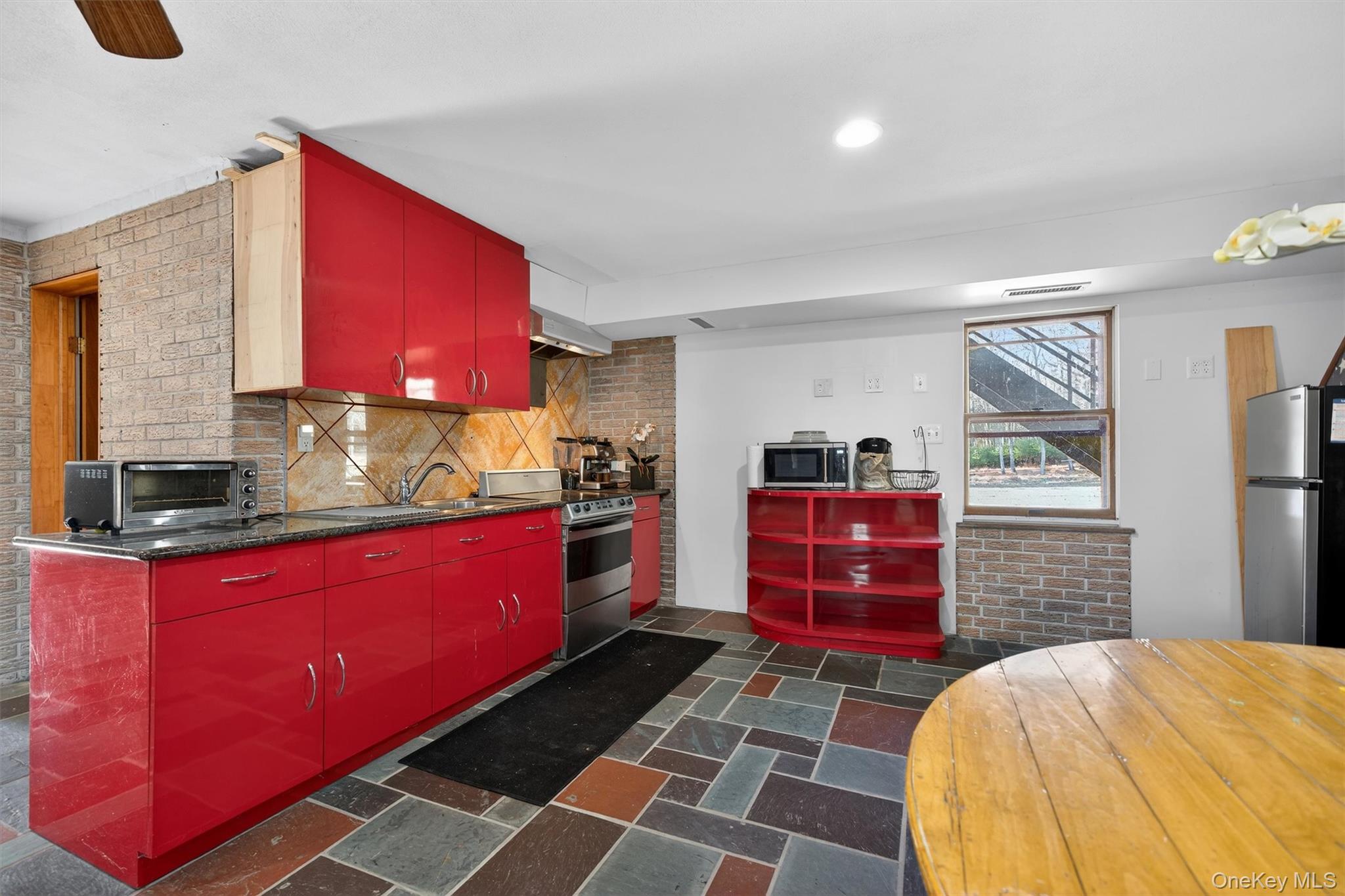 125 Dexheimer Road Narrowsburg, NY 12764 - Photo 31 of 50 Kitchen with red cabinetry, stainless steel appliances, tasteful backsplash, under cabinet range hood, and recessed lighting