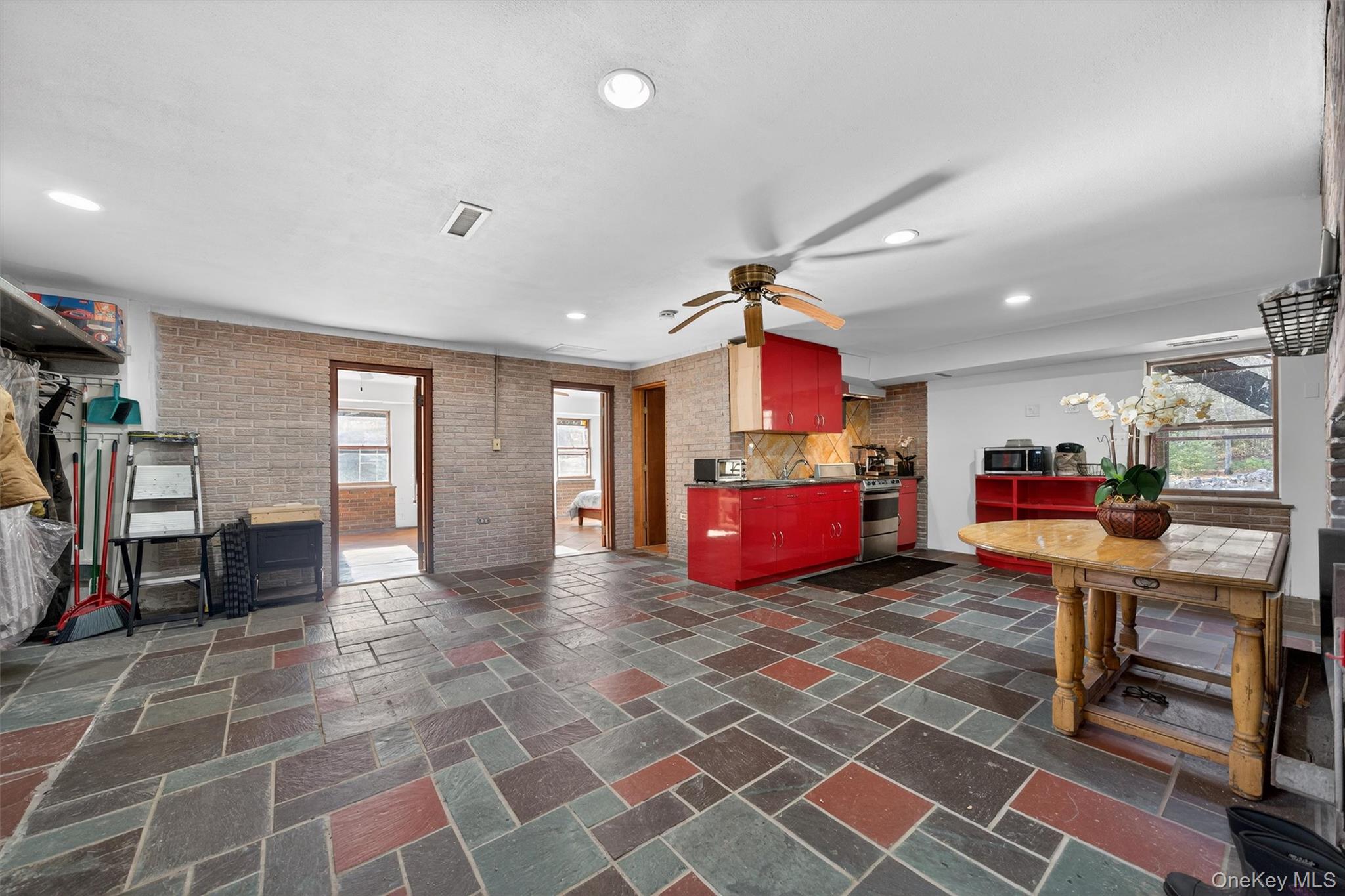 125 Dexheimer Road Narrowsburg, NY 12764 - Photo 32 of 50 Kitchen with recessed lighting, stone tile flooring, brick wall, stainless steel appliances, and ceiling fan