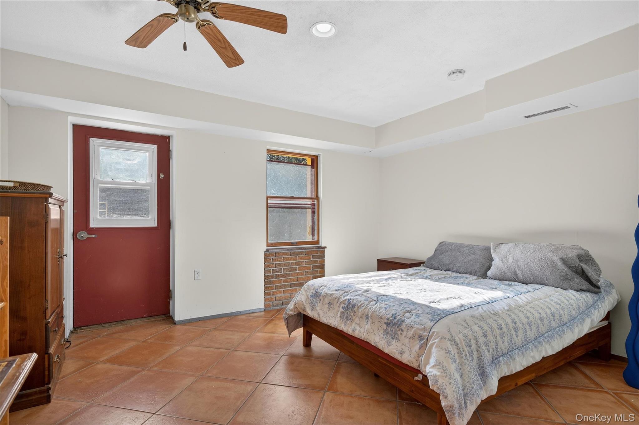 125 Dexheimer Road Narrowsburg, NY 12764 - Photo 33 of 50 Bedroom featuring multiple windows, light tile patterned floors, and a ceiling fan