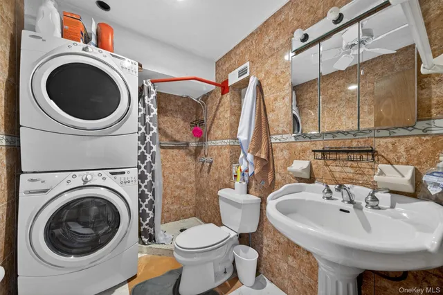 a bathroom with a sink a washer and dryer