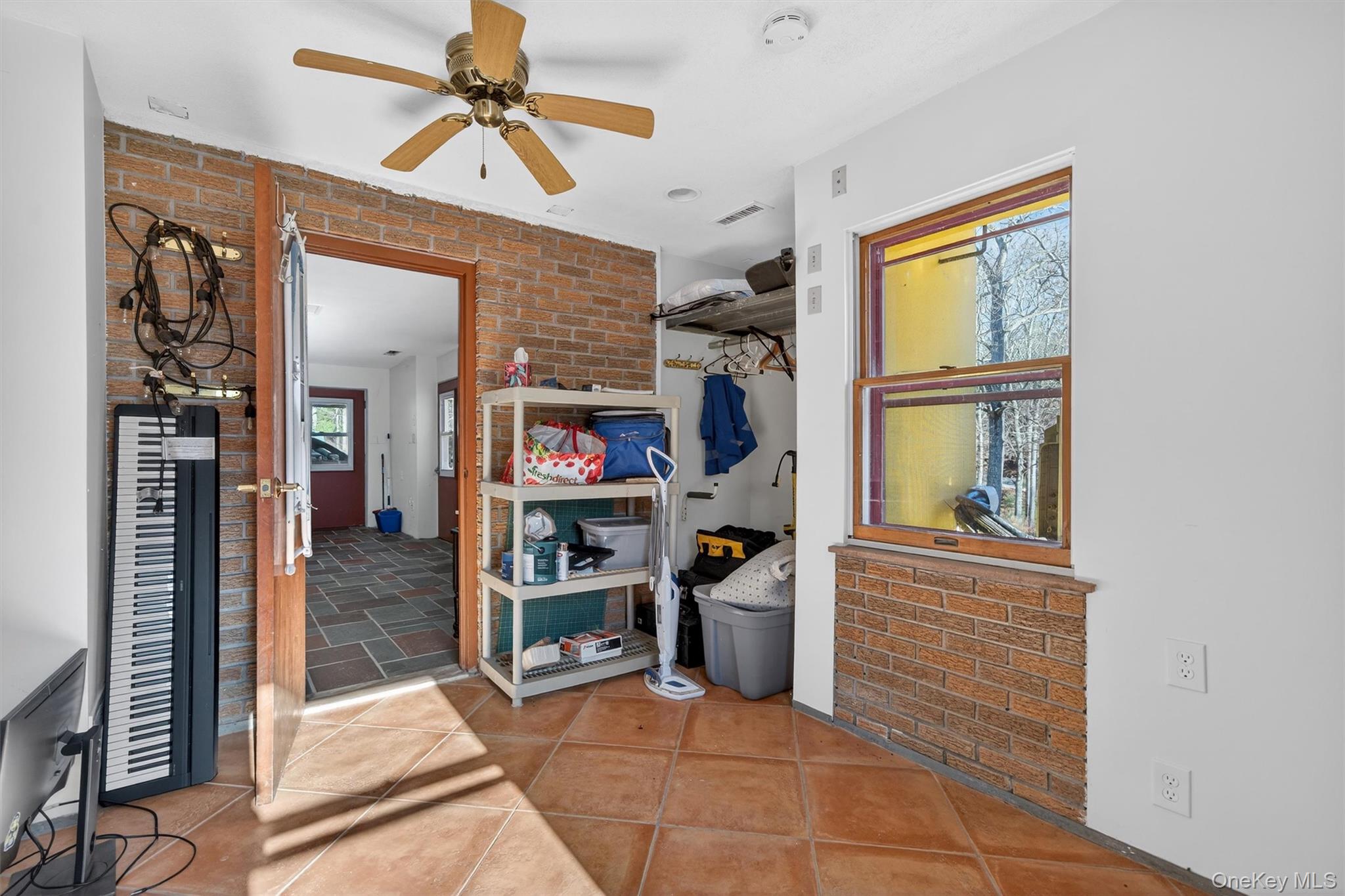 125 Dexheimer Road Narrowsburg, NY 12764 - Photo 37 of 50 Unfurnished bedroom with brick wall, ceiling fan, and a closet