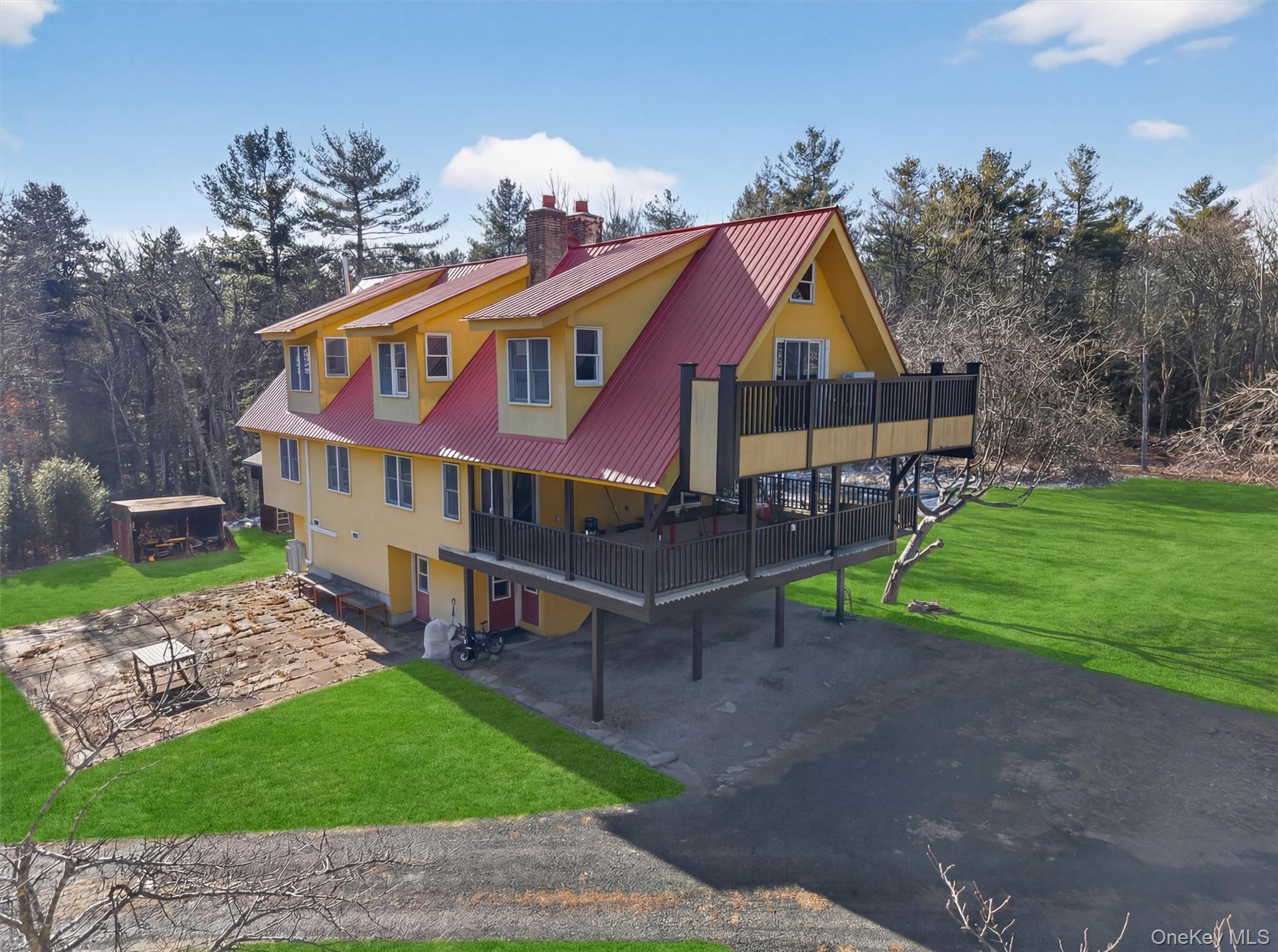 125 Dexheimer Road Narrowsburg, NY 12764 - Photo 39 of 50 View of property exterior featuring a yard, a wooden deck, a chimney, and a patio