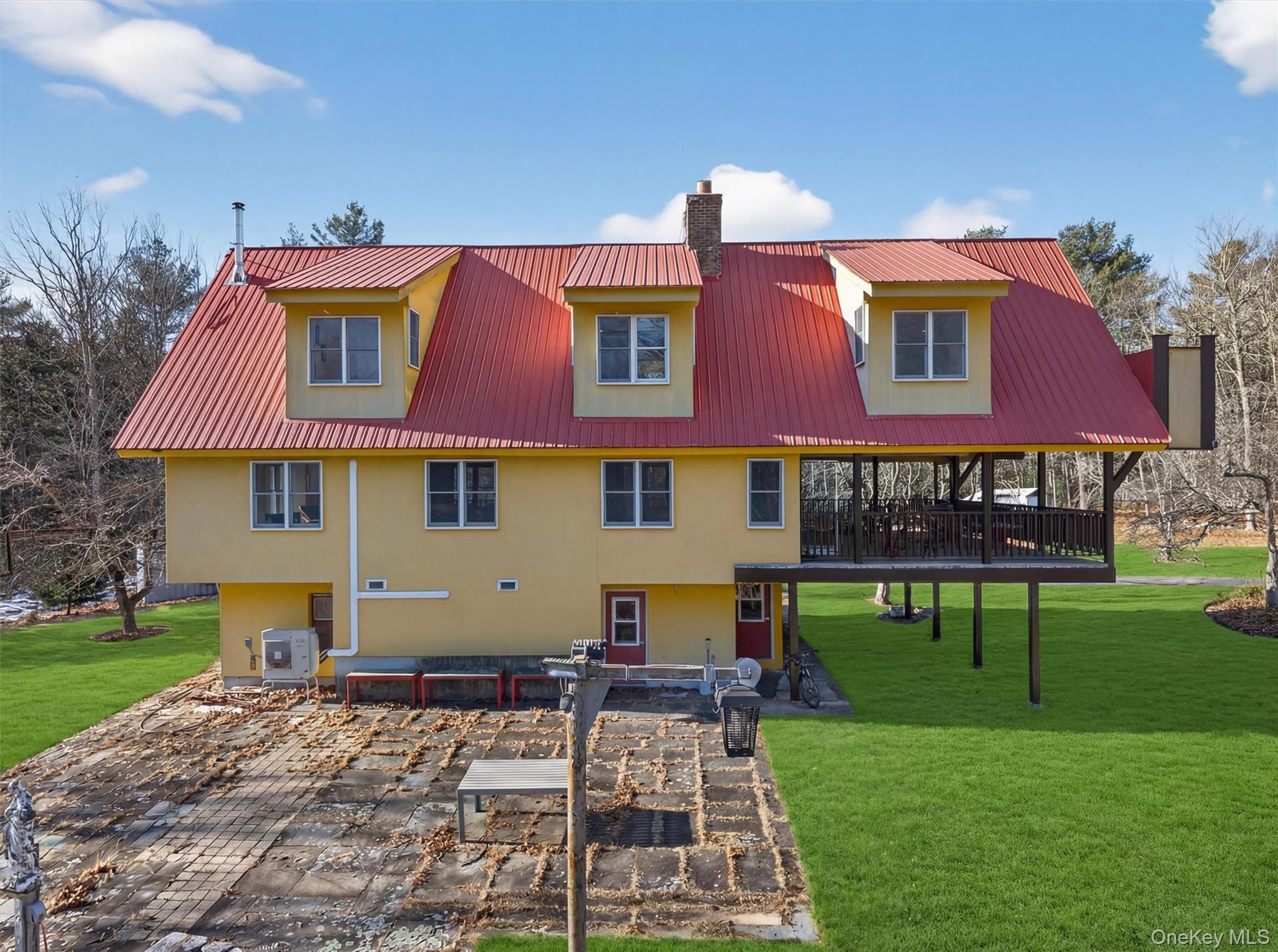 125 Dexheimer Road Narrowsburg, NY 12764 - Photo 47 of 50 Rear view of house featuring stucco siding, a chimney, a yard, a metal roof, and a deck