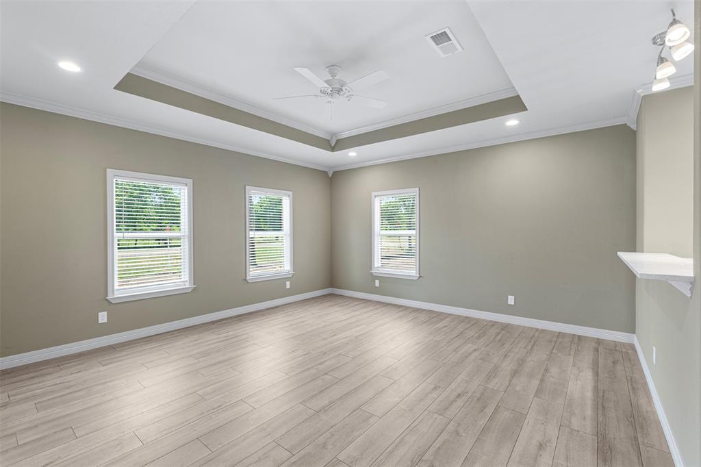 1011 Southeast County Road Corsicana, TX 75109 - Photo 8 of 40 a view of an empty room with wooden floor and a window