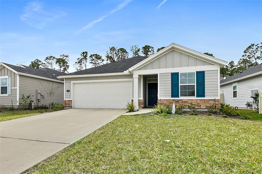 27 Willow Place Palm Coast, FL 32164 - Photo 1 of 1 a front view of a house with a yard and garage