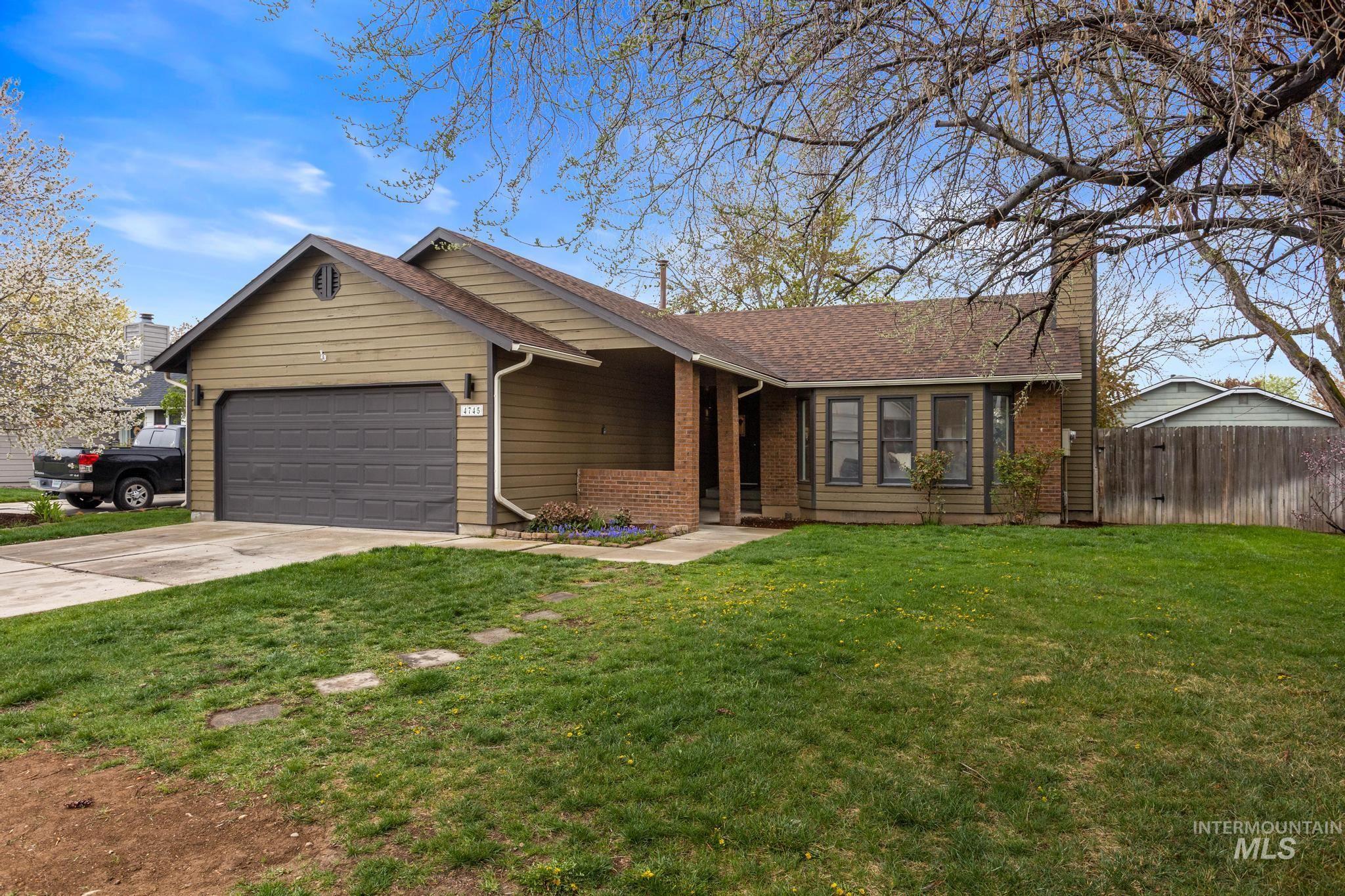 4745 North Oxbow Place Boise, ID 83713 - Photo 1 of 38 Single story home with driveway, a garage, brick siding, and a chimney