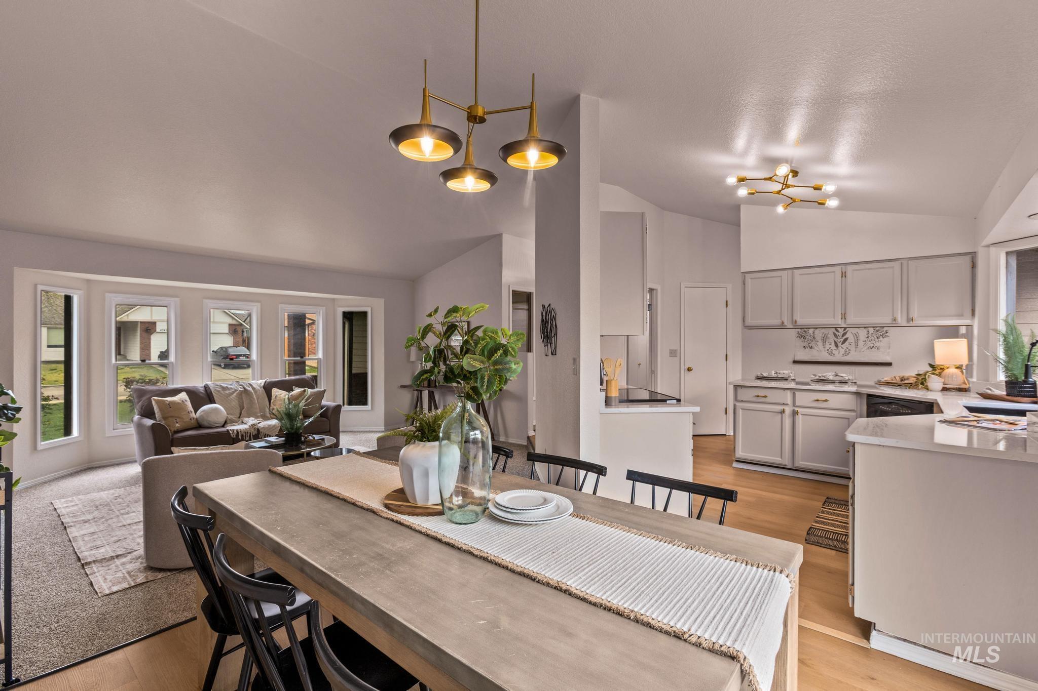 4745 North Oxbow Place Boise, ID 83713 - Photo 13 of 38 Dining space featuring light wood finished floors, lofted ceiling, and suspended lighting