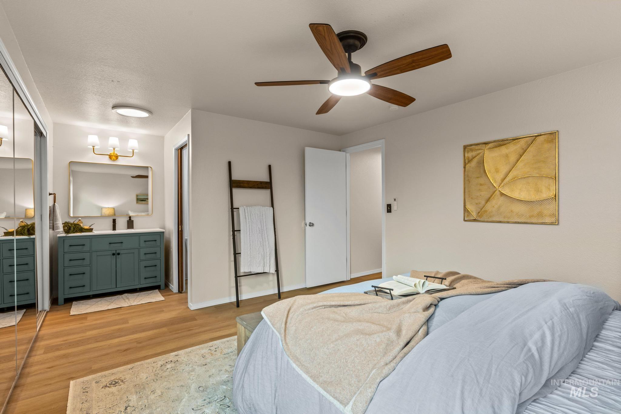4745 North Oxbow Place Boise, ID 83713 - Photo 23 of 38 Bedroom with light wood-style flooring, ceiling fan, and connected bathroom