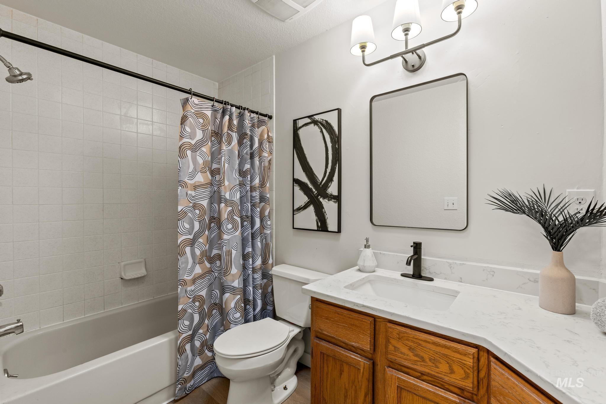 4745 North Oxbow Place Boise, ID 83713 - Photo 28 of 38 Bathroom featuring vanity and shower / tub combo with curtain