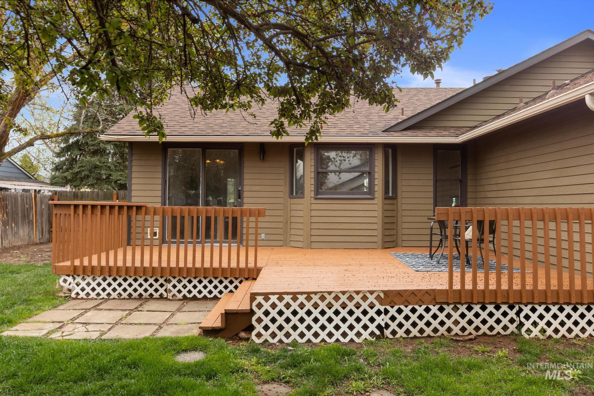 4745 North Oxbow Place Boise, ID 83713 - Photo 35 of 38 Rear view of house with roof with shingles and a wooden deck