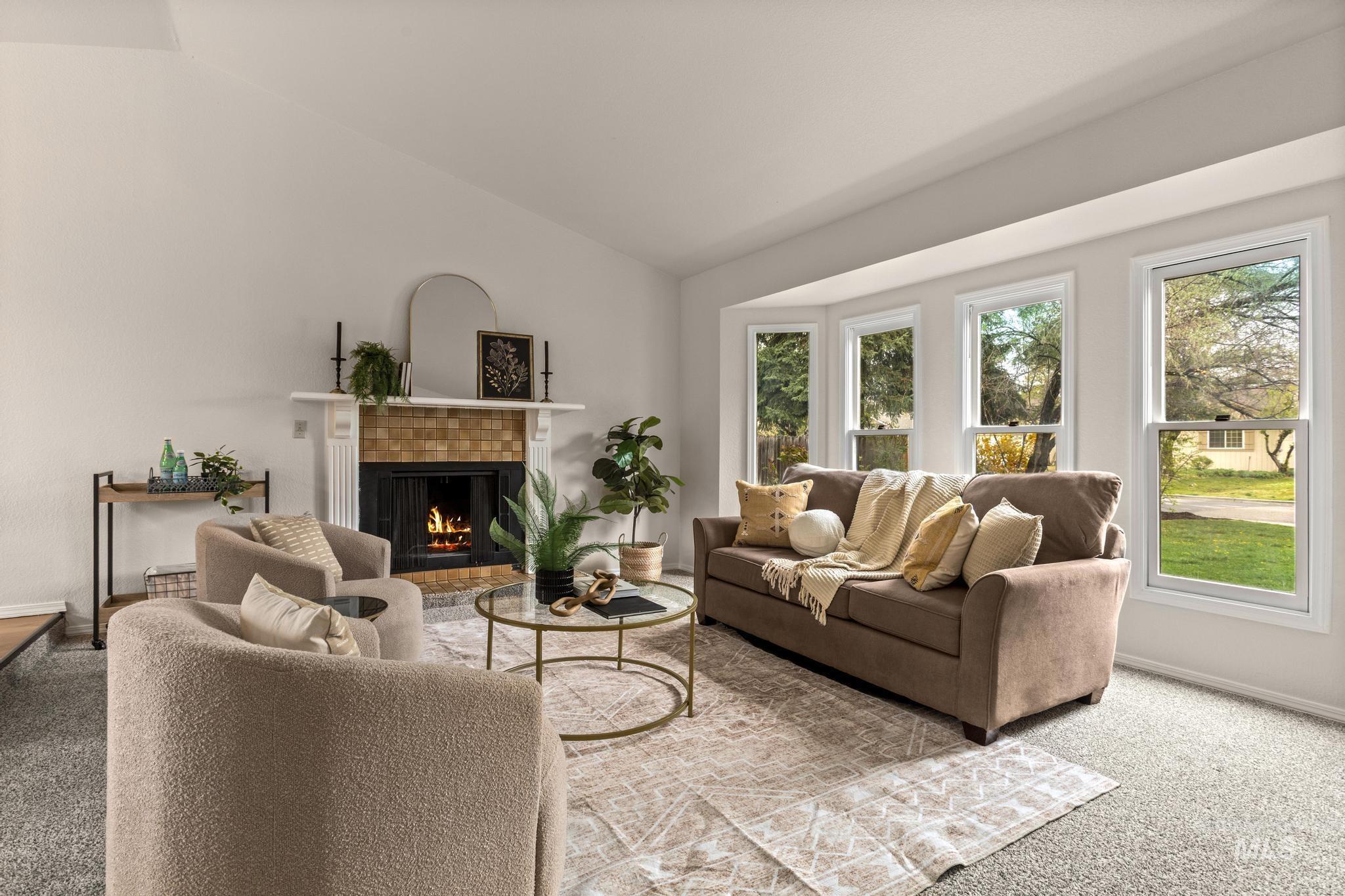 4745 North Oxbow Place Boise, ID 83713 - Photo 6 of 38 Carpeted living room featuring vaulted ceiling and a fireplace