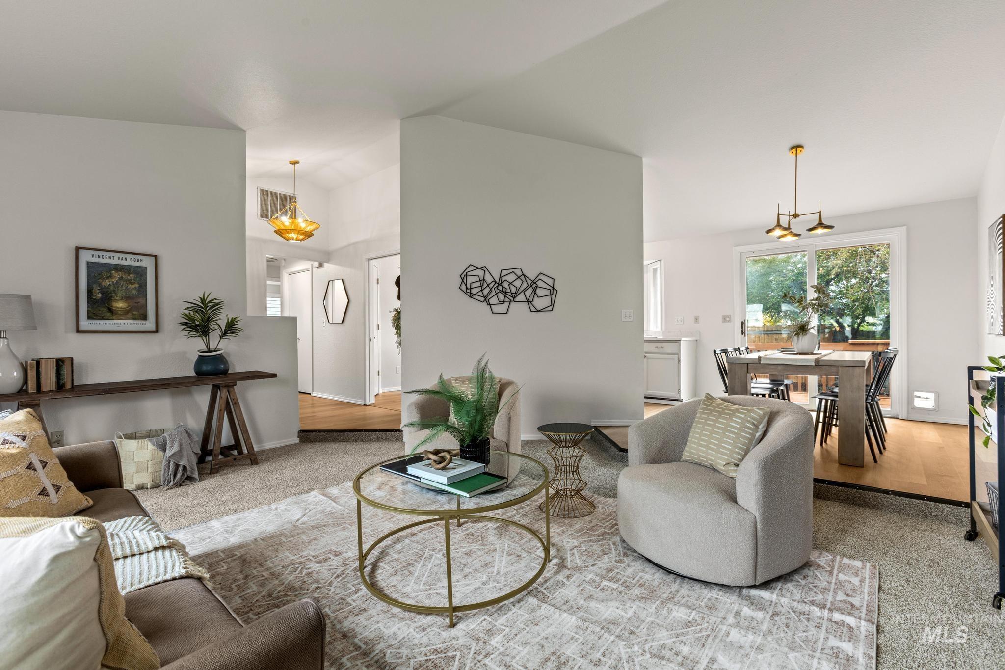 4745 North Oxbow Place Boise, ID 83713 - Photo 10 of 38 Carpeted living room with lofted ceiling and suspended lighting