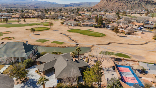 980 Cactus Circle St. George, UT 84790 - Photo 46 of 77 Aerial perspective of suburban area with a local golf course and a water and mountain view