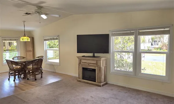 a view of a livingroom with furniture window and fireplace