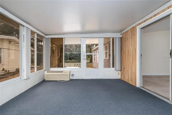 a view of room with furniture and large windows