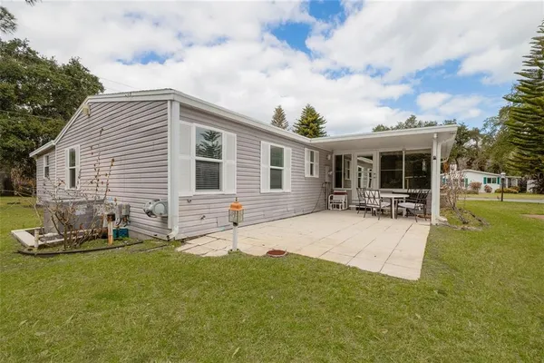 a house view with swimming pool and garden space