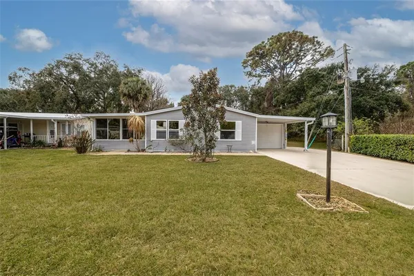 a front view of house with yard having swimming pool