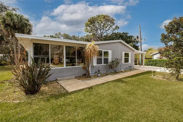 a front view of a house with a yard table and chairs