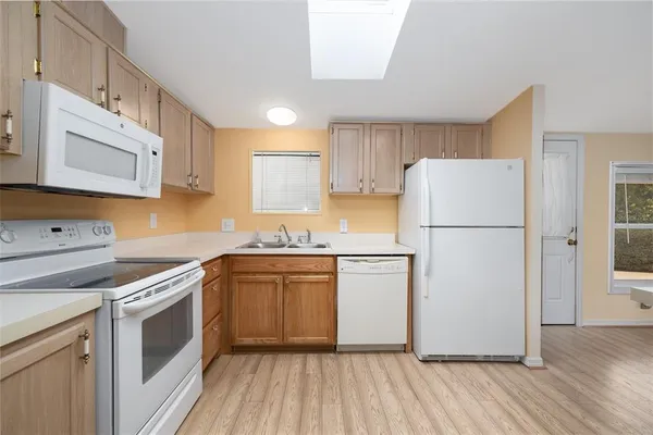a kitchen with a refrigerator sink stove and cabinets