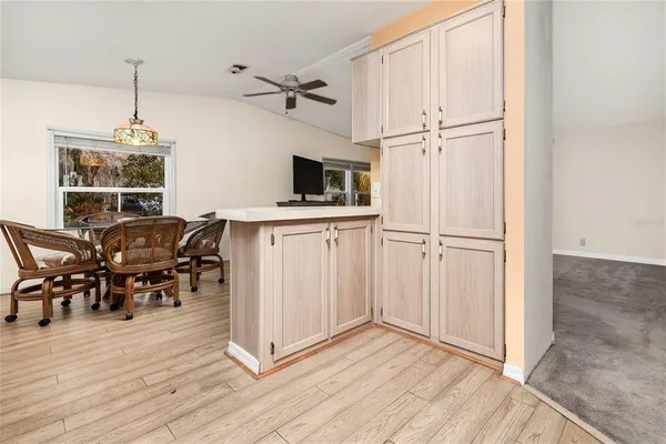a view of a kitchen with furniture and wooden floor