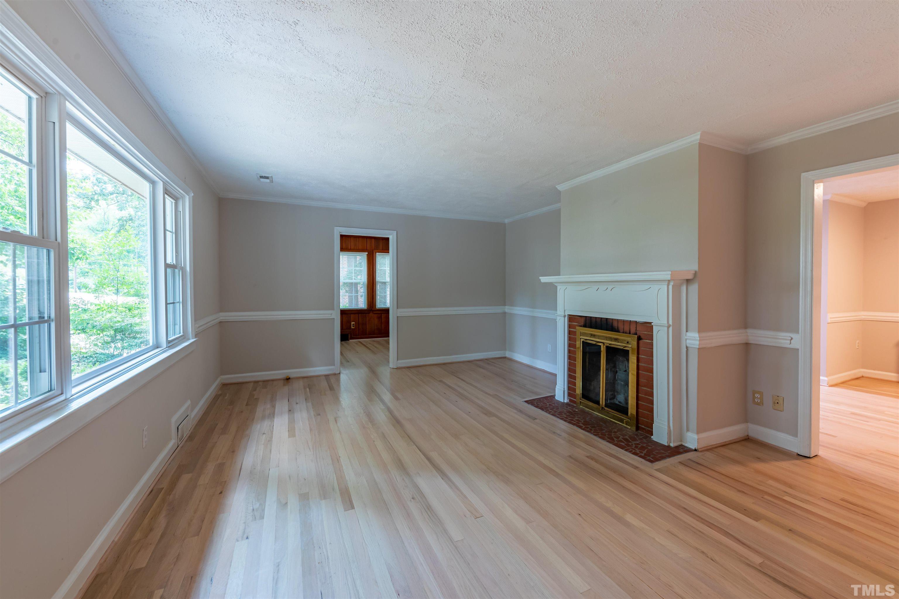 1511 Duplin Road Raleigh, NC 27607 - Photo 2 of 23 wooden floor fireplace and windows in an empty room