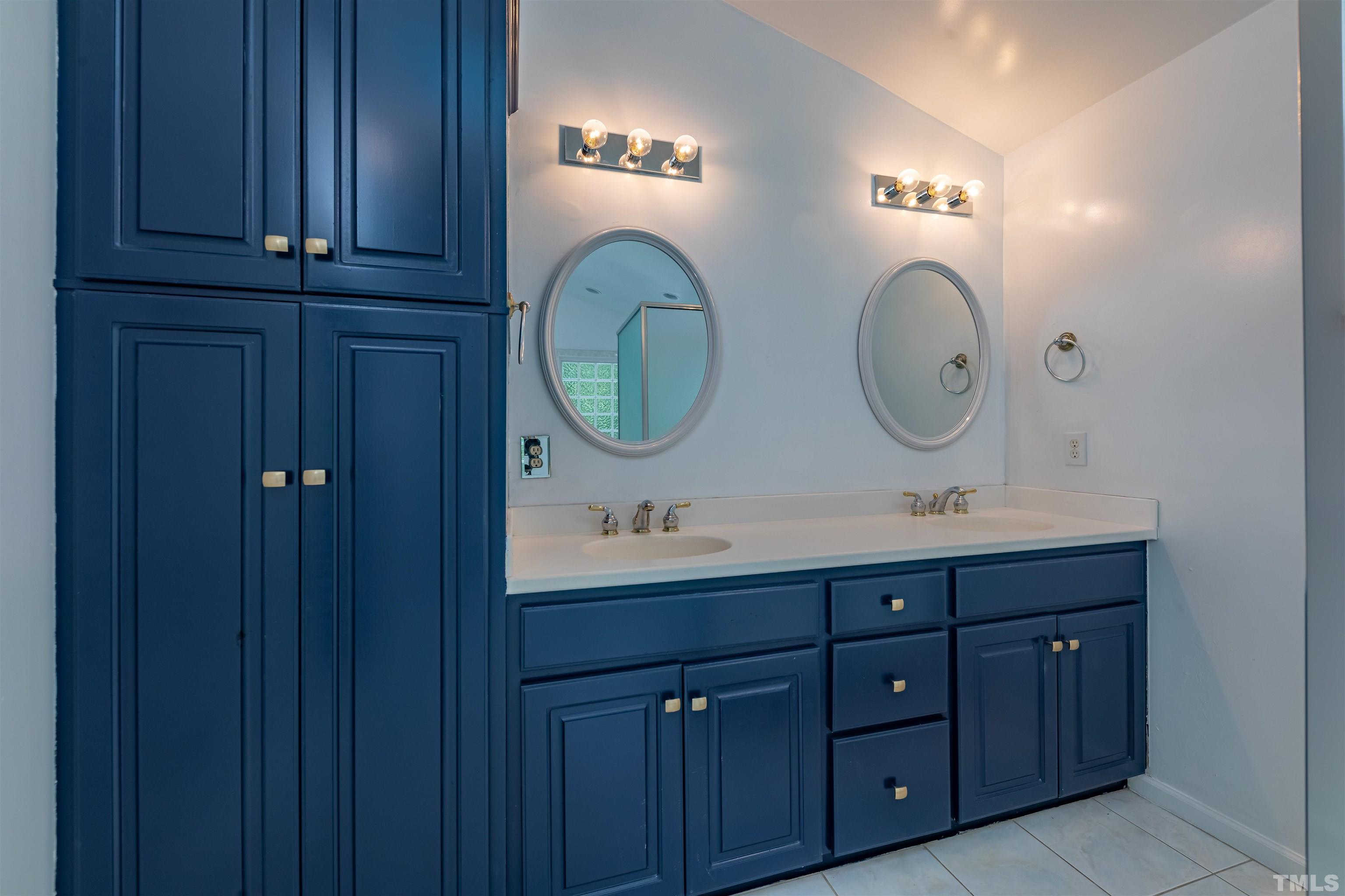 1511 Duplin Road Raleigh, NC 27607 - Photo 11 of 23 a bathroom with a sink and two mirror