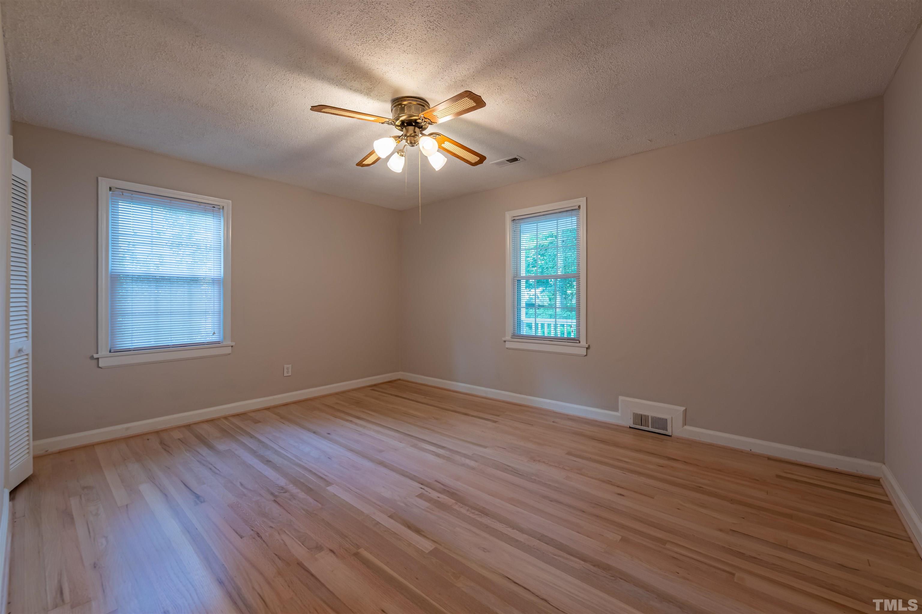 1511 Duplin Road Raleigh, NC 27607 - Photo 14 of 23 a view of an empty room with wooden floor and a window