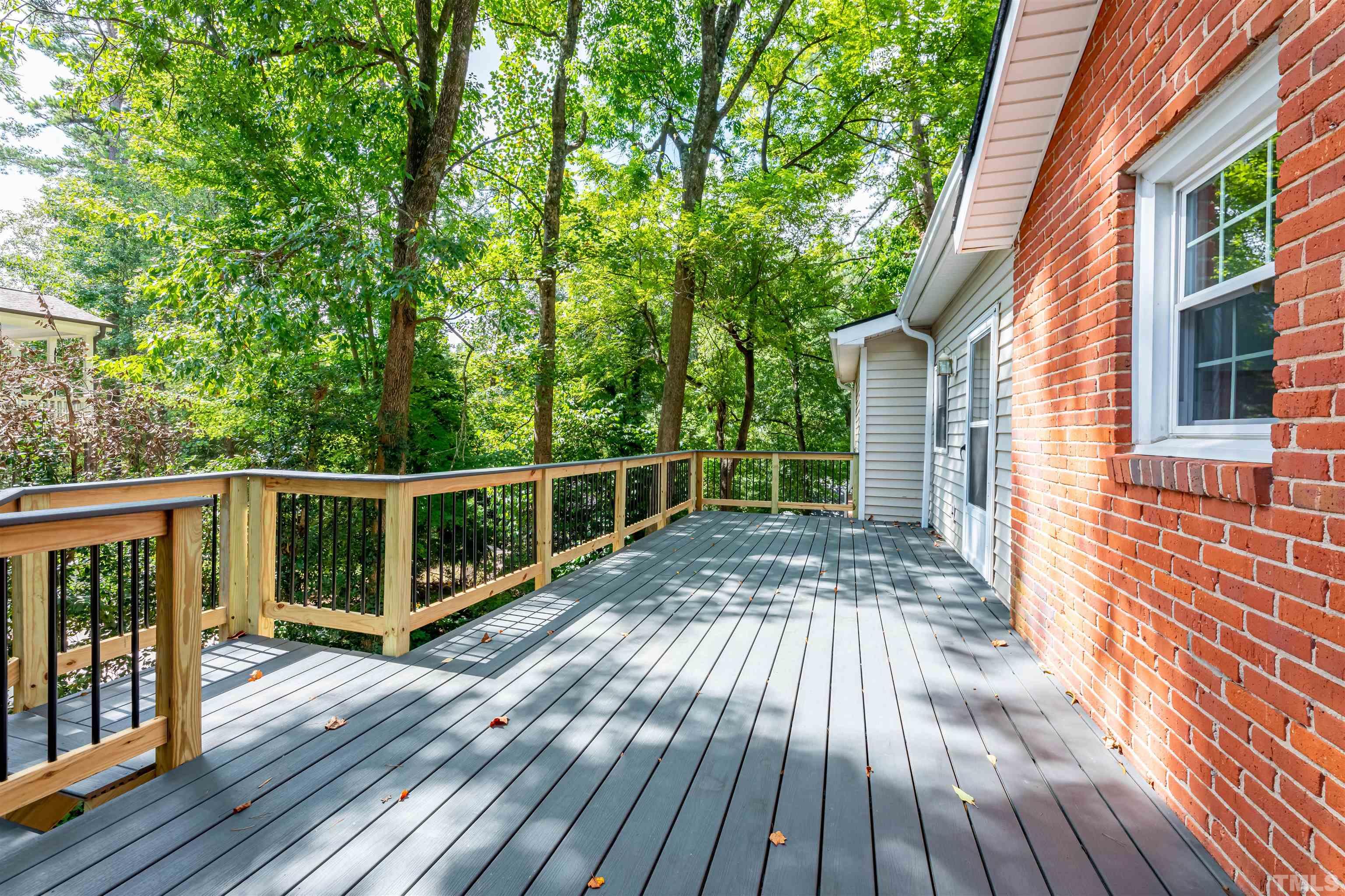1511 Duplin Road Raleigh, NC 27607 - Photo 18 of 23 a view of a wooden deck with a yard