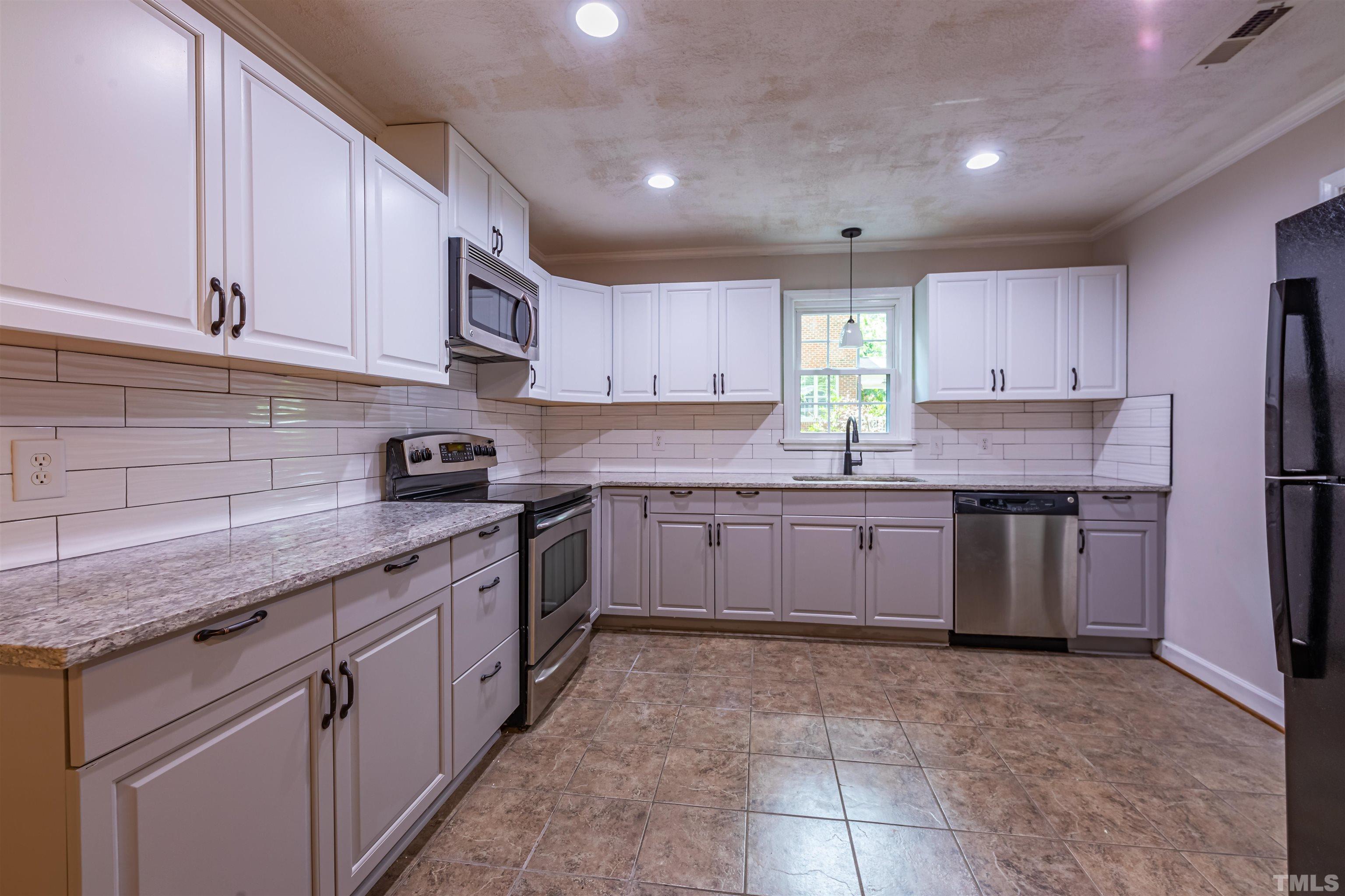 1511 Duplin Road Raleigh, NC 27607 - Photo 6 of 23 a kitchen with stainless steel appliances granite countertop a stove a sink dishwasher and a refrigerator