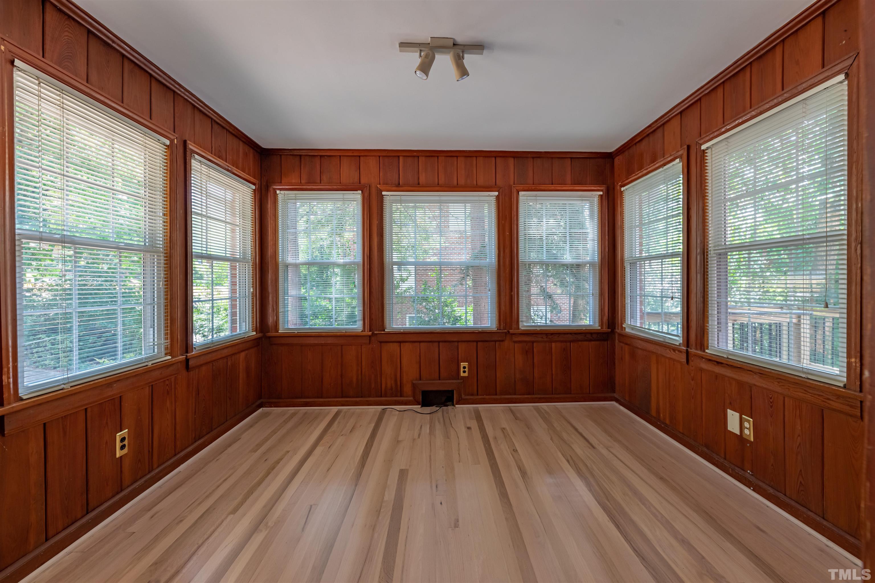 1511 Duplin Road Raleigh, NC 27607 - Photo 7 of 23 a view of an empty room with wooden floor and a window