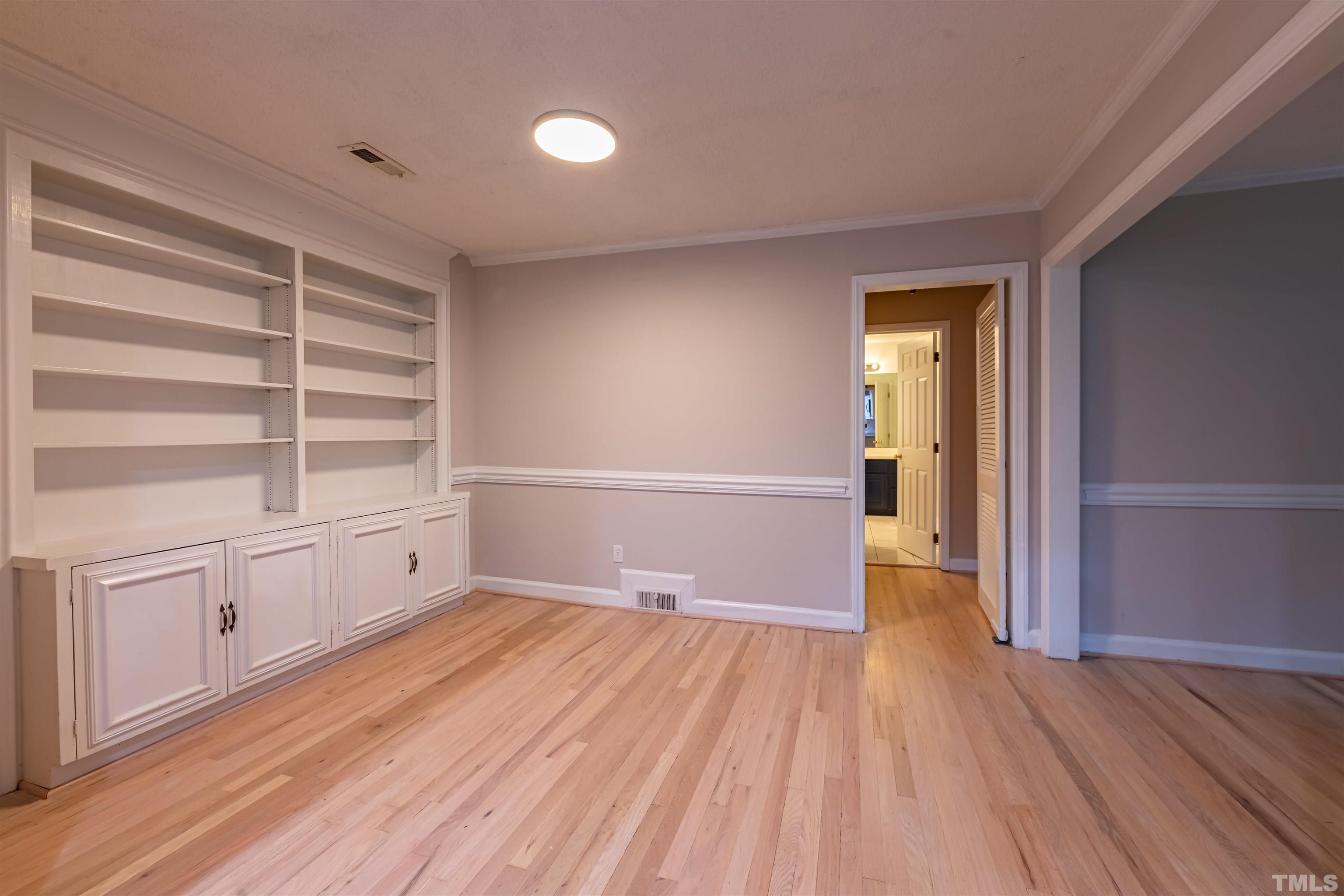 1511 Duplin Road Raleigh, NC 27607 - Photo 8 of 23 a view of an empty room with a window and wooden floor