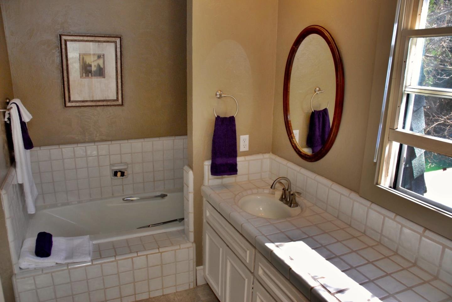 3510 Hecker Pass Road, Unit D Gilroy, CA 95020 - Photo 14 of 23 a bathroom with a tub a sink and a mirror