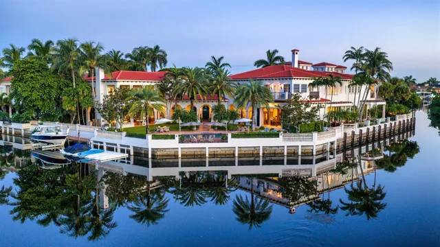 an aerial view of a house with a yard and outdoor seating