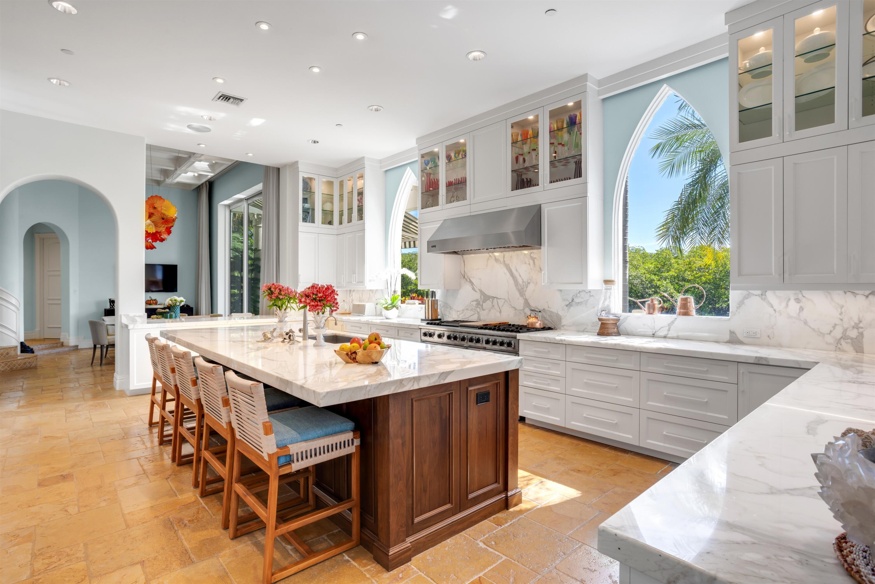 799 Northeast 45th Road Boca Raton, FL 33431 - Photo 22 of 90 a living room with stainless steel appliances kitchen island granite countertop a table chairs in it and a large window
