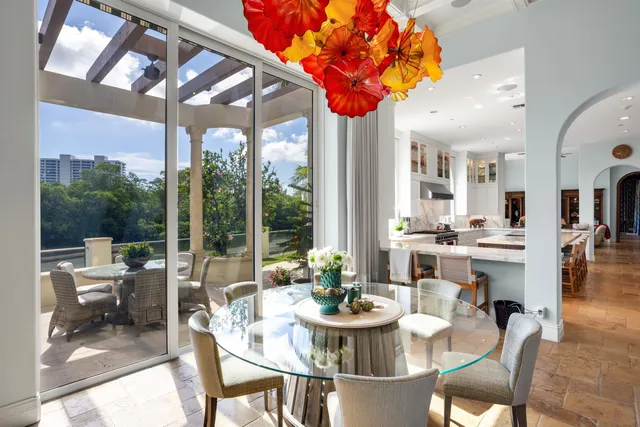 a front view of a house with a garden and trees