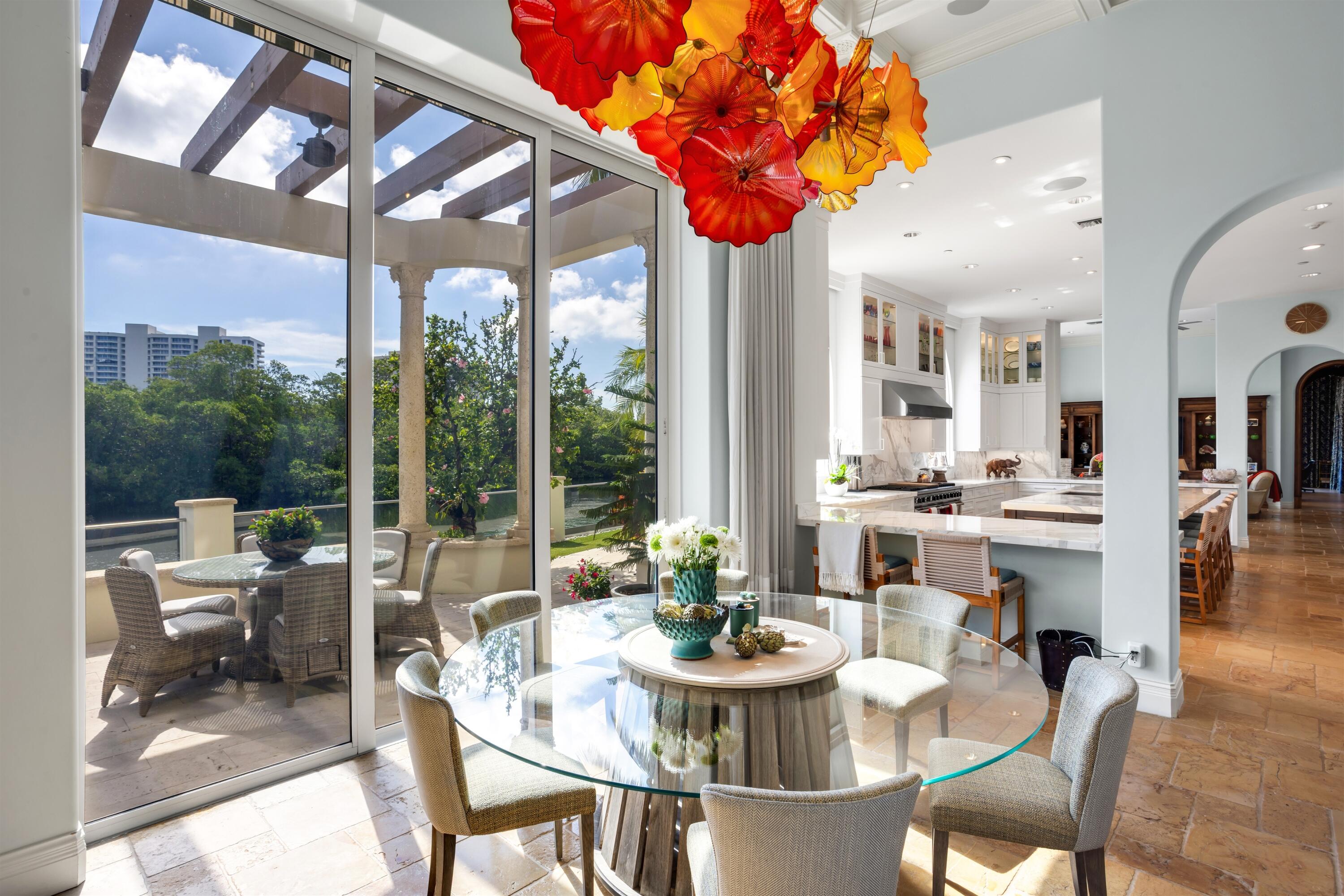 799 Northeast 45th Road Boca Raton, FL 33431 - Photo 28 of 90 a view of a dining room with furniture large windows and wooden floor