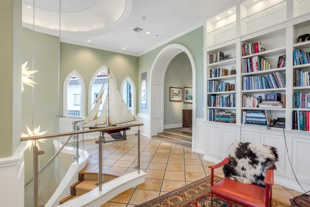 a view of a swimming pool with a table and chairs under an umbrella