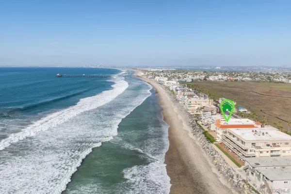 a view of an ocean beach and mountain