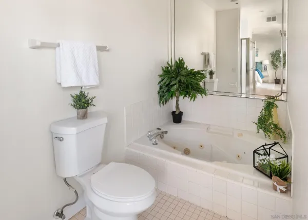 a view of a hallway with wooden floor and entryway