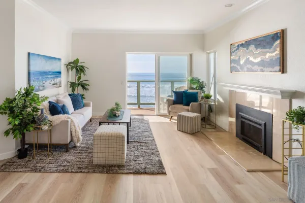 a living room with furniture large window and fireplace