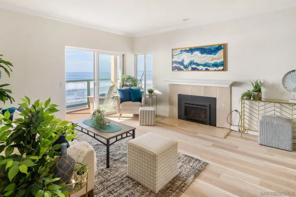 a living room with furniture a large window and a fireplace