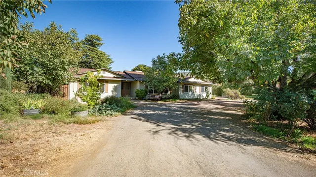 a view of a dining room with furniture a chandelier and wooden floor