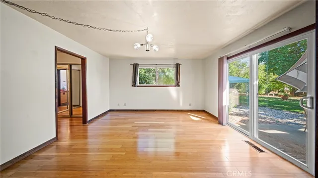 a view of patio with chairs and table under an umbrella
