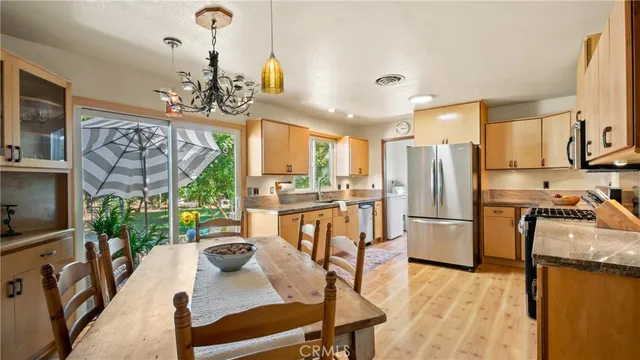 a living room with furniture a fireplace and a floor to ceiling window