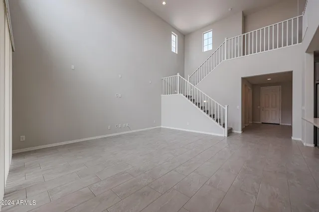 an empty room with a ceiling fan and a ceiling fan